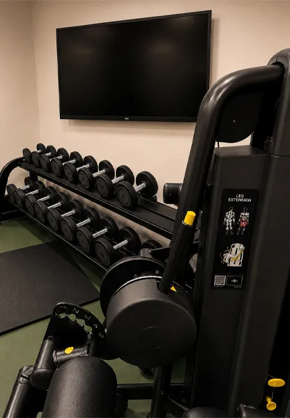 Technogym leg extension machine and dumbbell rack in the Hotel Royal Menaggio gym